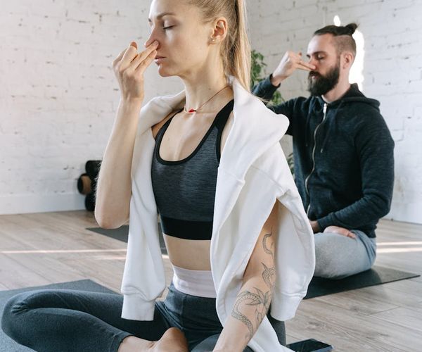 Person meditating peacefully in a bright, calm room.